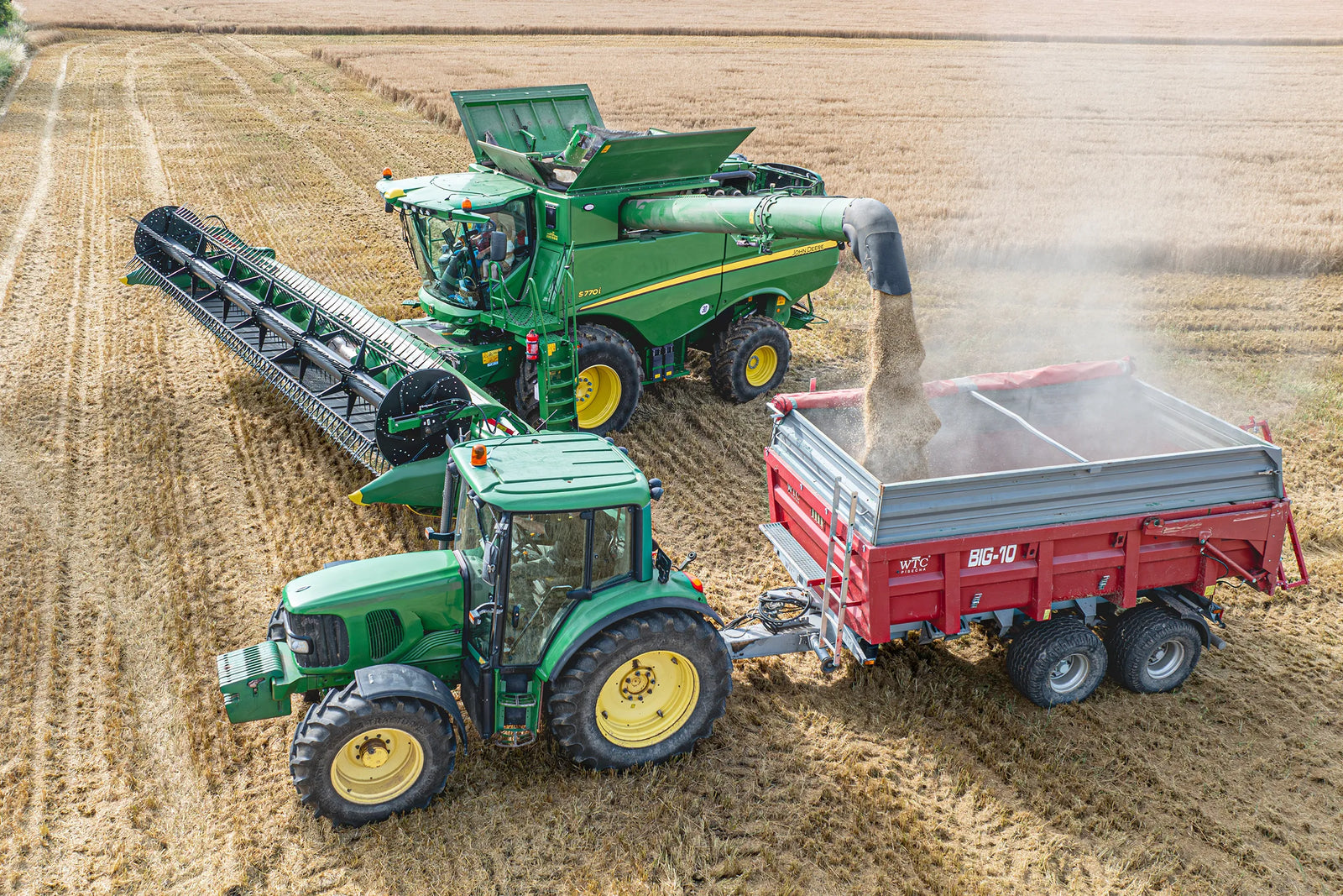 farmland equipment, tractors and combine harvesters in field - agriculture insurance